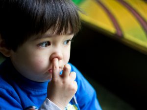 Boy picking nose